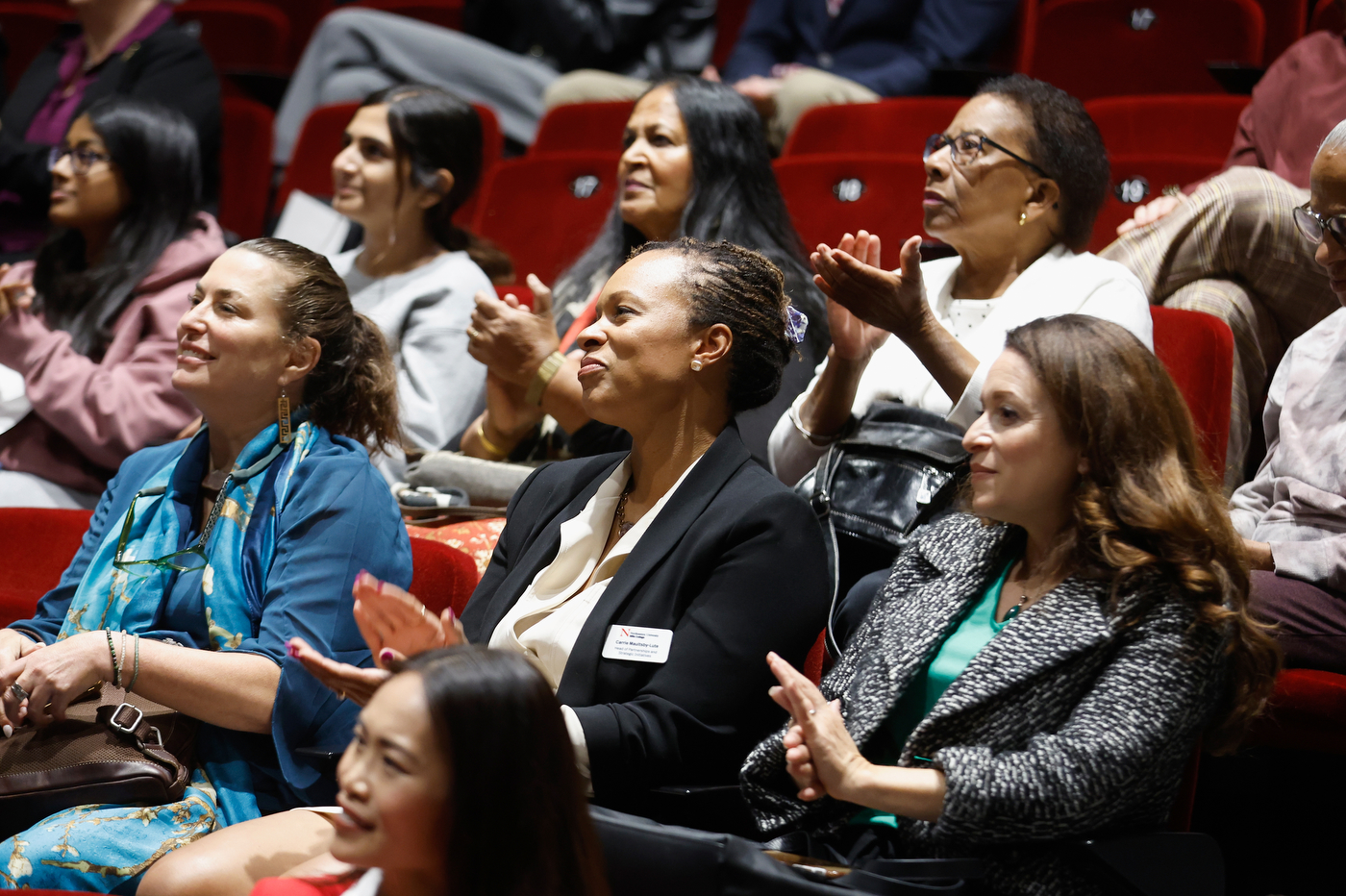 Audience members clapping for Dr. Rita Ng. 