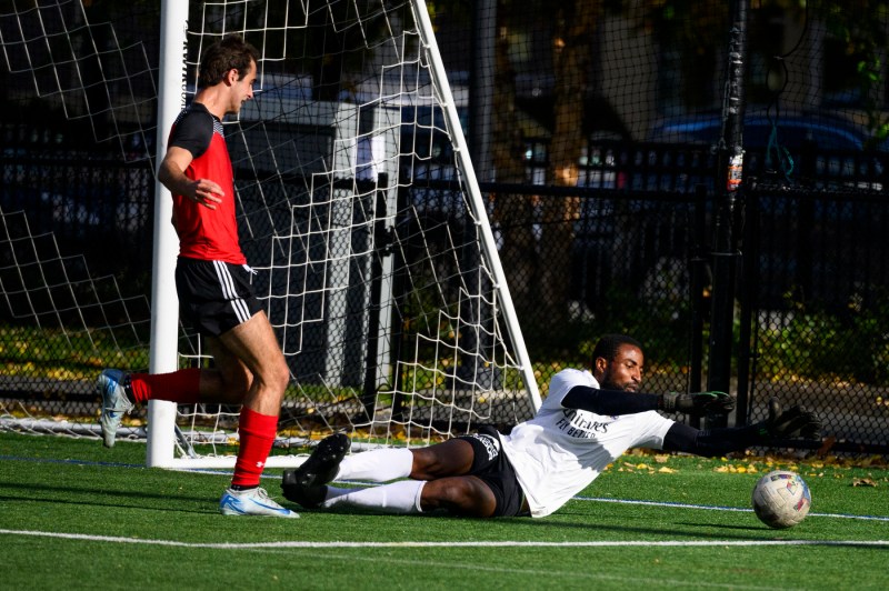 A goalkeeper saving a shot on net at Carter Field.