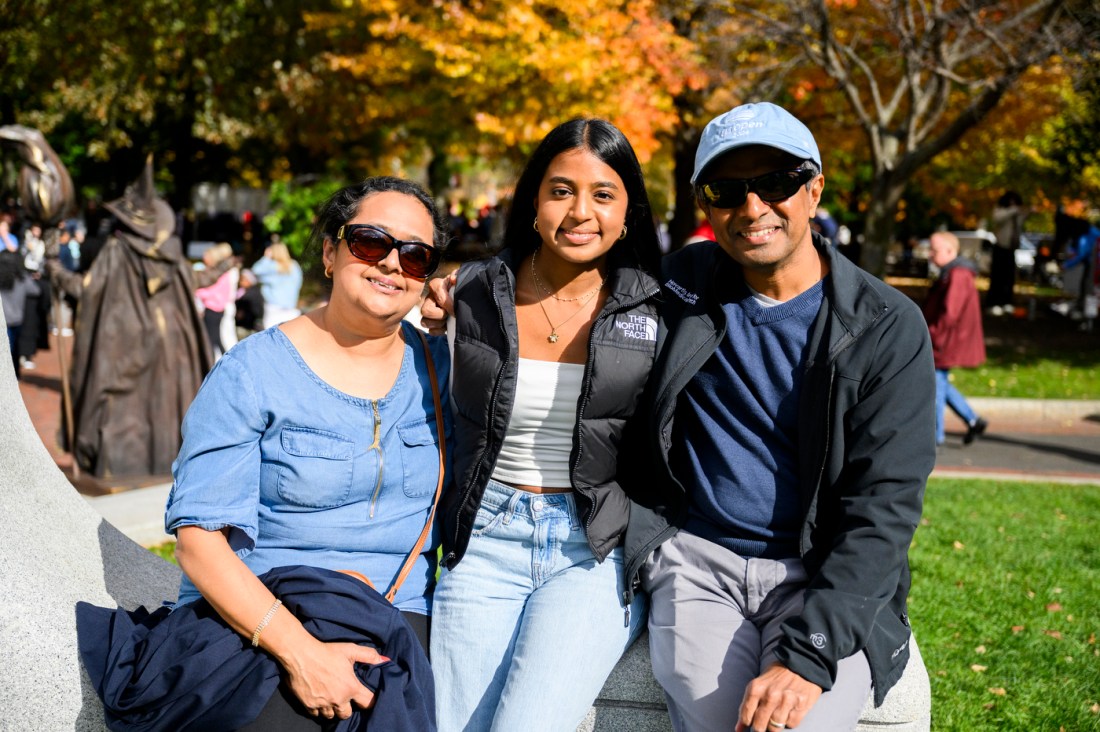 A student posing with their family. 