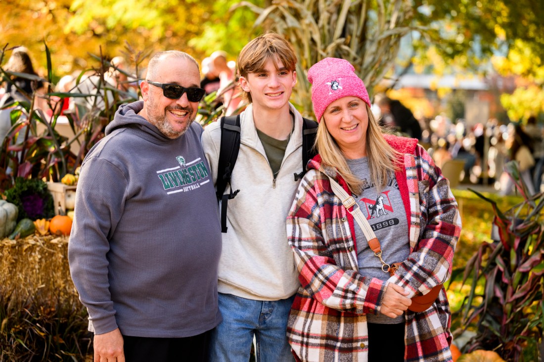 A family poses together outside on the Boston campus. 