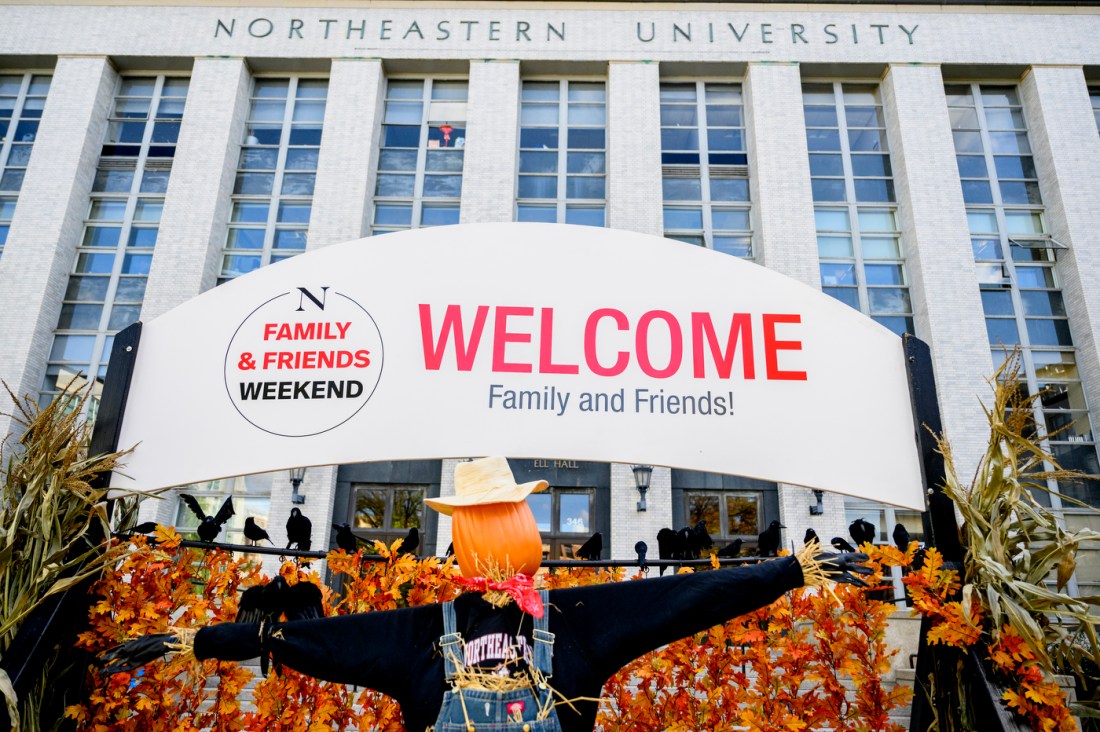 A large welcome sign in front of Ell Hall on the Boston campus. 