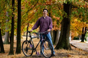 Sam Whitby posing with his bicycle.