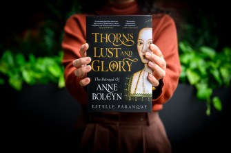 Estelle Paranque holding up a copy of her book 'Thorns, Lust and Glory'.