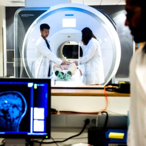 Two people using an MRI machine.