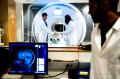 Two people using an MRI machine.