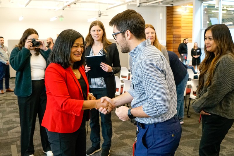 U.S. Rep. Pramila Jayapal shaking the hand of another person. 