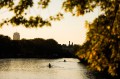 Two boats of rowers on the Charles River at sunset.