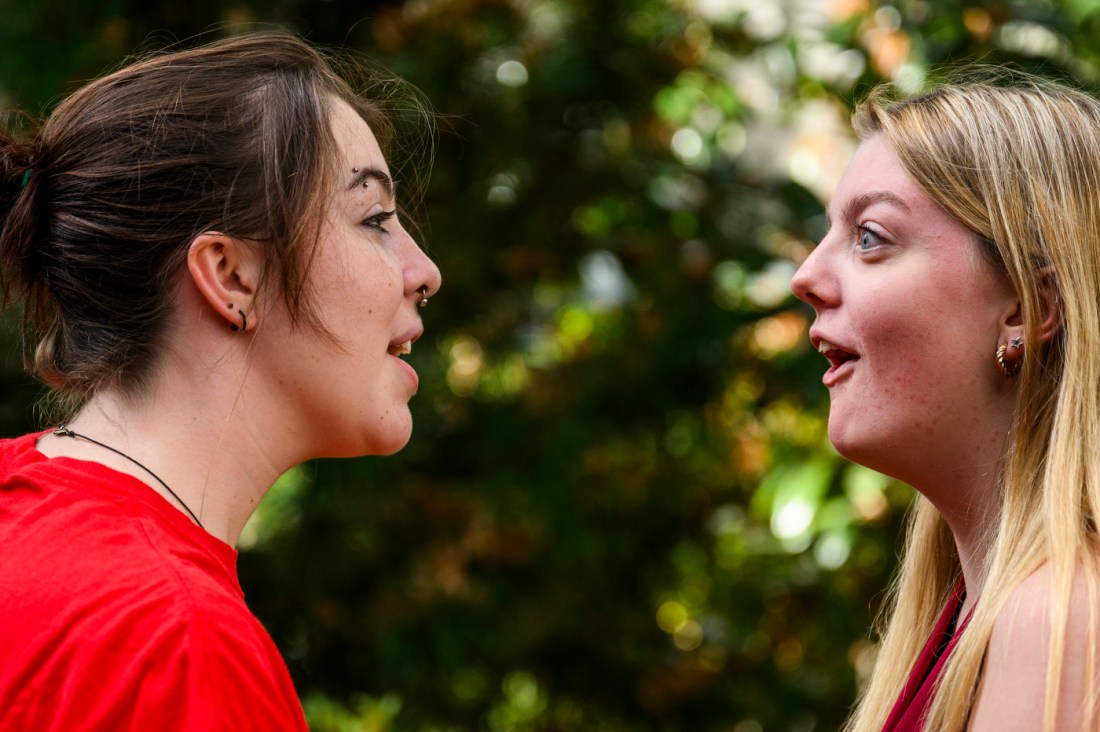 Two members of the Shakespeare society acting in each other's face. 