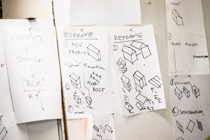 Sketches of modular housing pinned to a board.