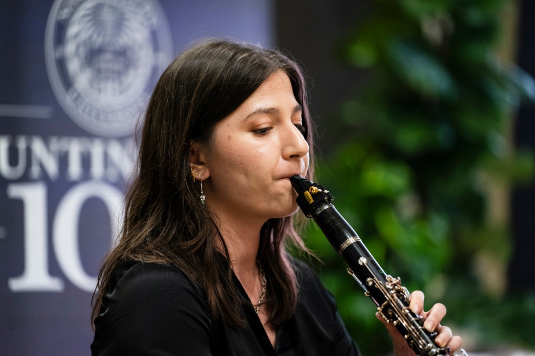 A person playing the clarinet at the Huntington 100 induction ceremony.