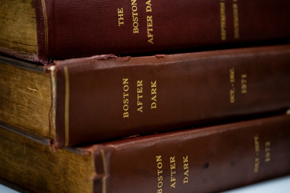 Stacks of historical 'Boston After Dark' books.