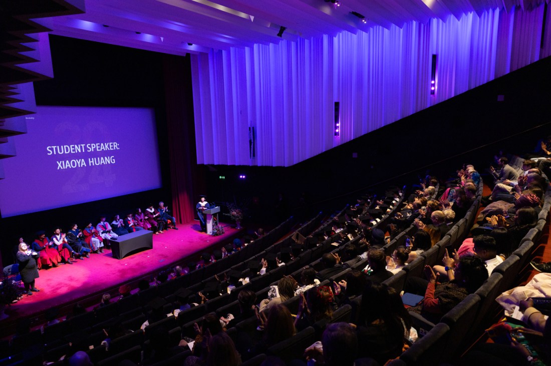 Audience members sitting in the Barbican centre for graduation.