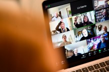 A group of people on a Zoom call on a laptop.