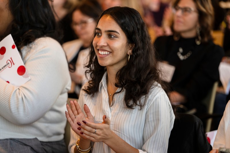 An audience member smiling at the Women Who Empower Summit.