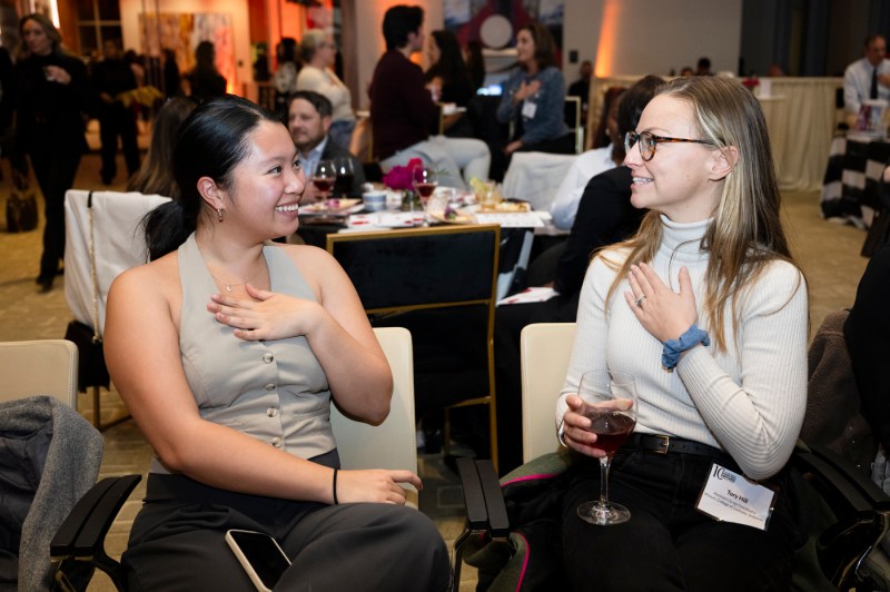 Two audience members chatting at the Women Who Empower event.