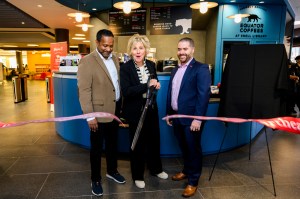 Helen Russell cutting a ribbon at the new Equator Coffees in Snell Library.