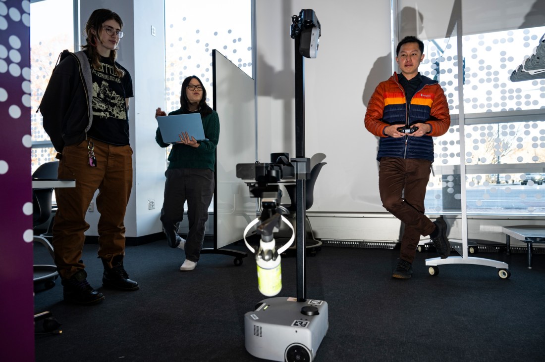 Zhi Tan, Emily Taylor, and Althea Masetti Zanini working with a robot named Marlo.