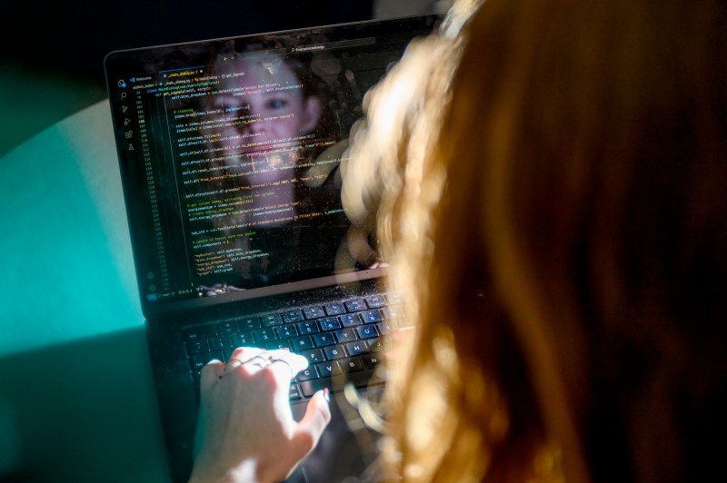 Ava Knight typing code onto a laptop.