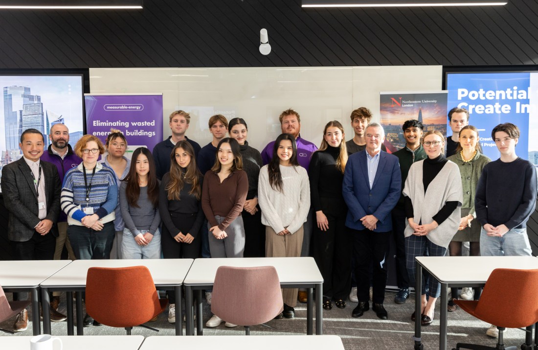 Students posing with clients from the measurable.energy firm.