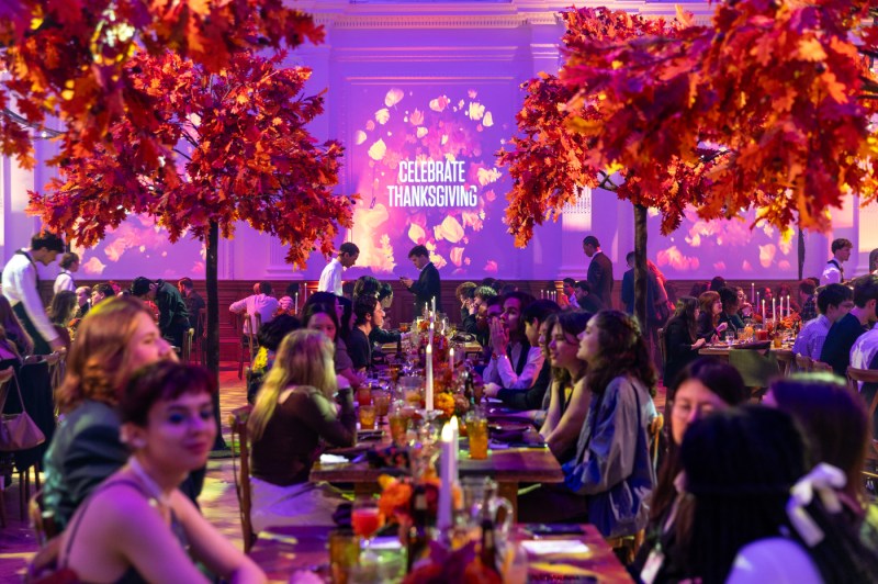 Guests dine in a beautifully decorated Lindley Hall during Northeastern’s Thanksgiving dinner in London.