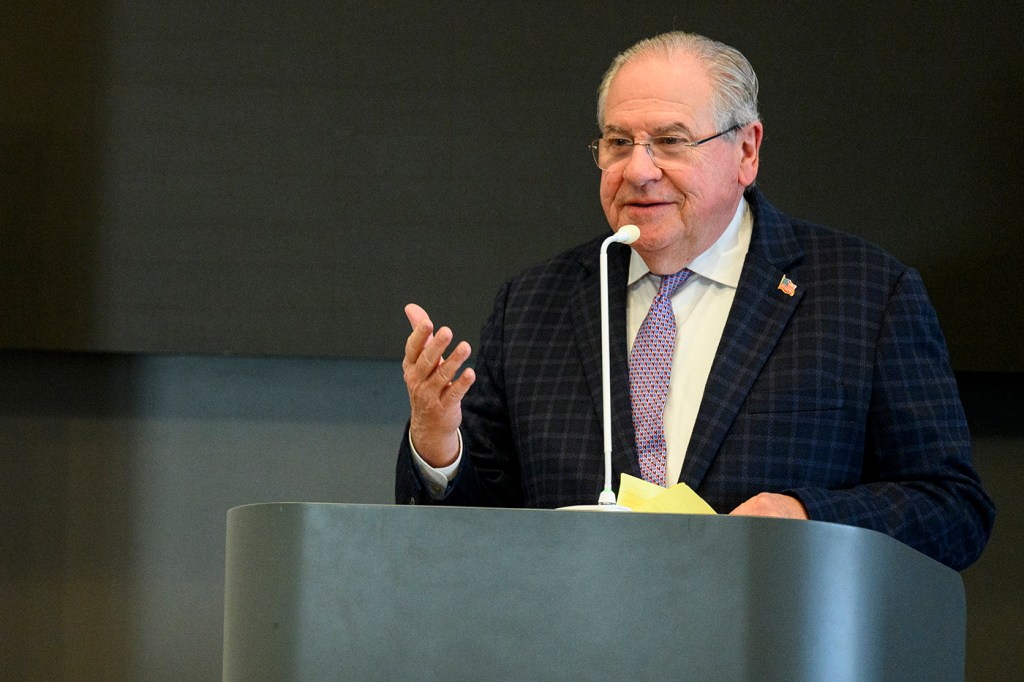 Bob DeLeo speaking at a podium.