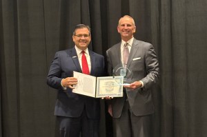 Donald Hoffer posing with another person and his award.