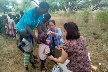 Two students working with people in Kenya.