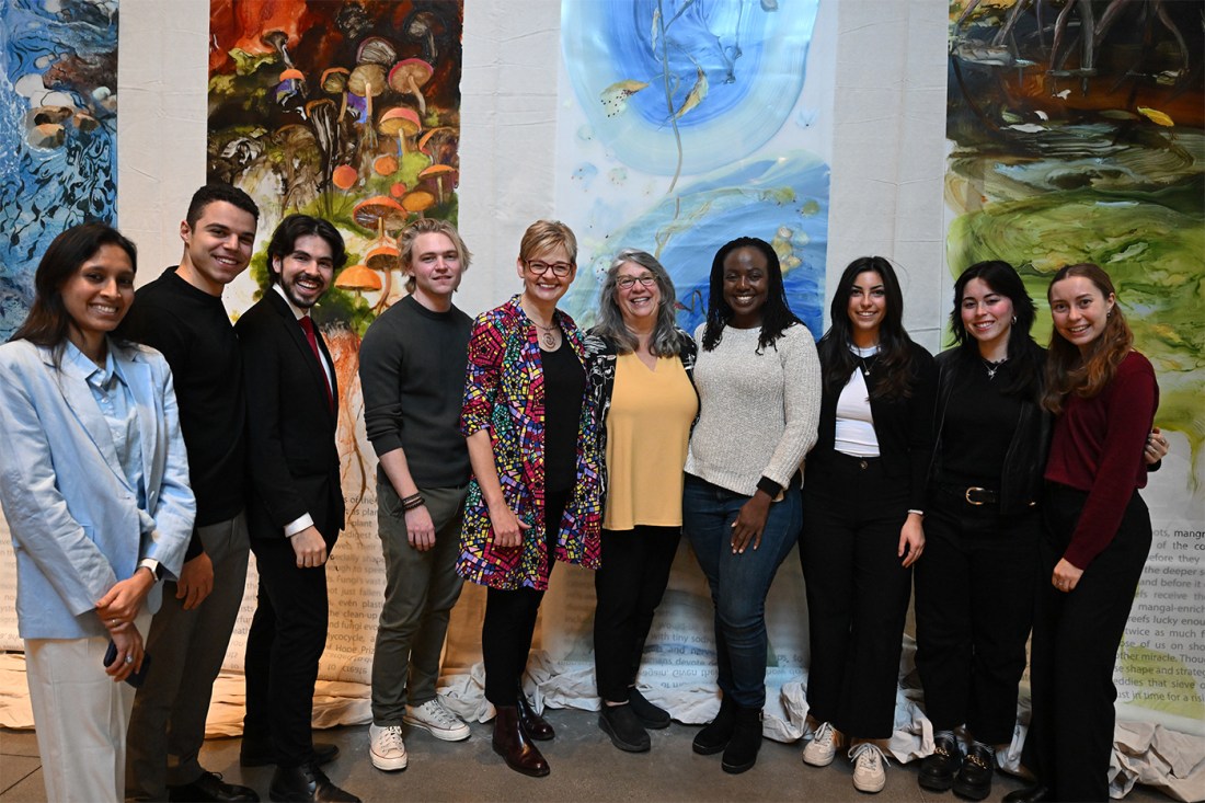 Maria Ivanova posing with a group of people at the TED Planet Action summit.