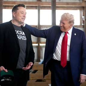 Donald Trump standing next to Elon Musk with his hand on his shoulder.