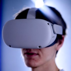 A person wearing a virtual reality headset in a softly lit environment.