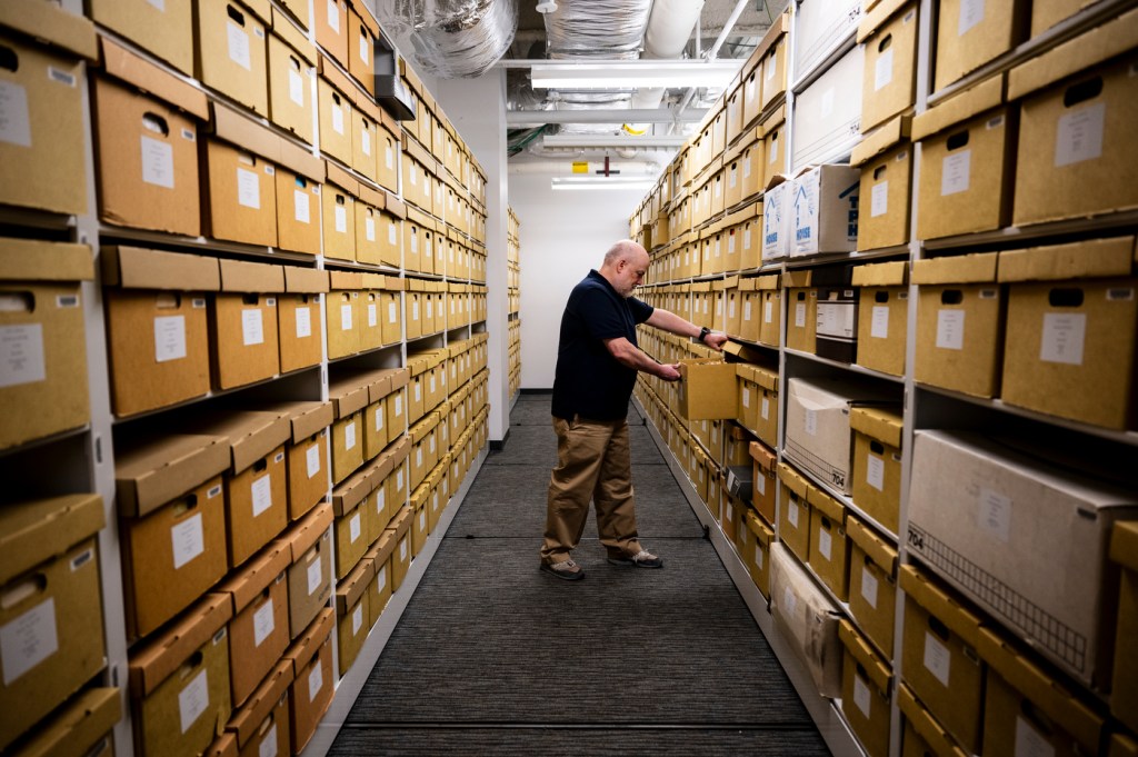 David Lavoie looks through boxes of archives.