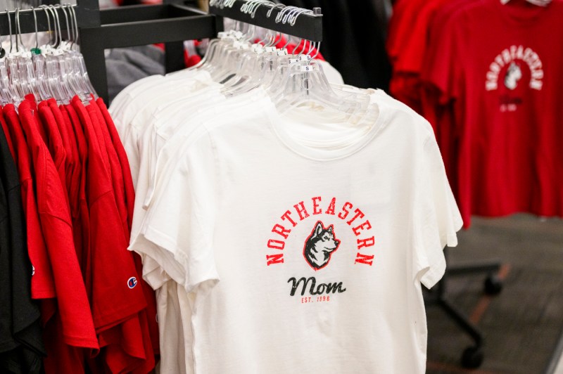 White Northeastern Mom t-shirts on a rack.