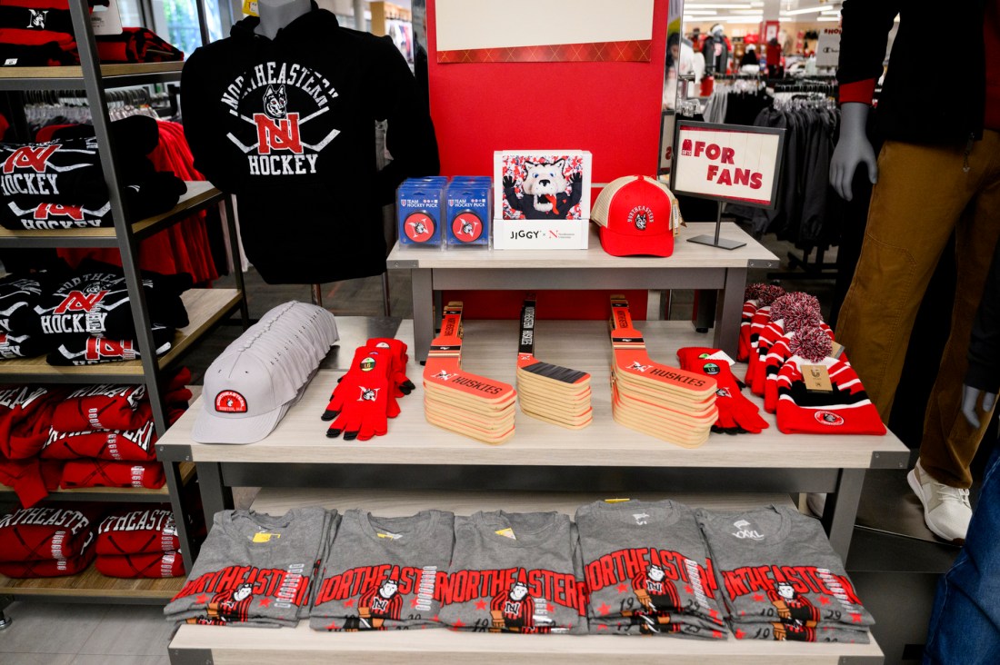 A table of Northeastern branded merchandise, a lot of it in the color red, in the bookstore.