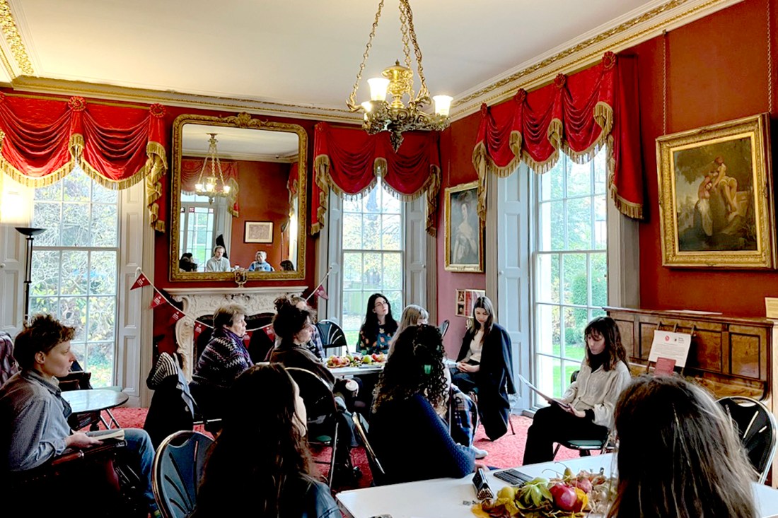 People sitting in a room in the home of John Keats.