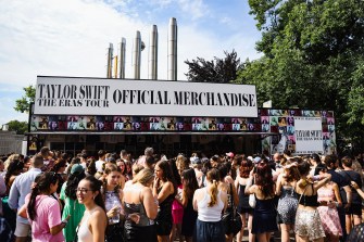 Fans lined up outside of the Eras Tour official merchandise stand.