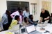 A group of people sitting around laptops in Ghana.