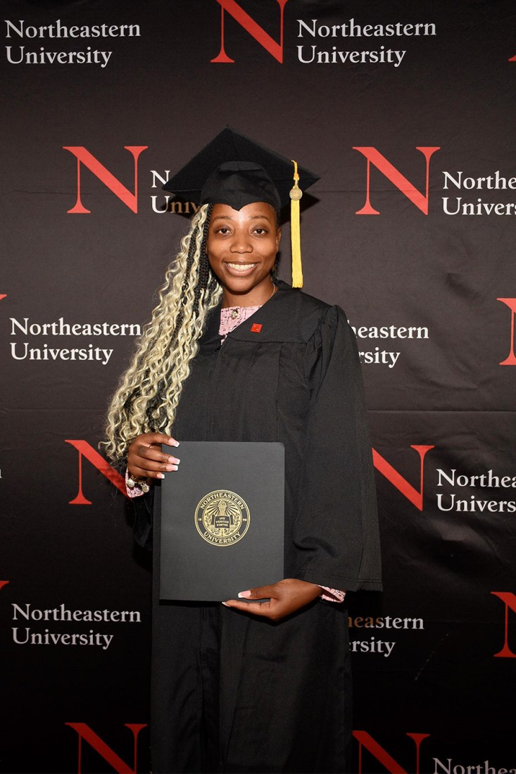 Tamara Palmer holding her diploma.