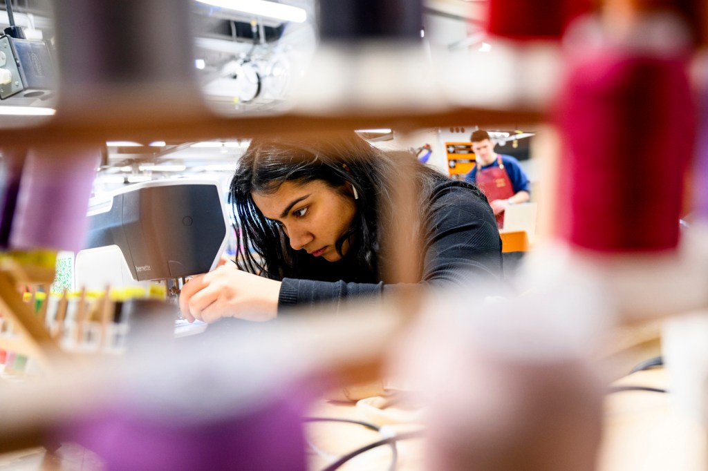 A person using a sewing machine in the Boston makerspace.