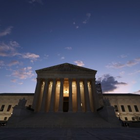 The U.S. Supreme Court building photographed at dusk.