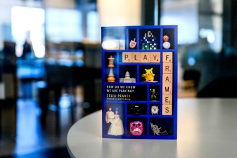 Celia Pearce's book "Playframes" standing up on a table.