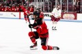 A Northeastern hockey player celebrates after scoring a goal.