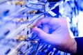 A person adjusting a quantum computing board.