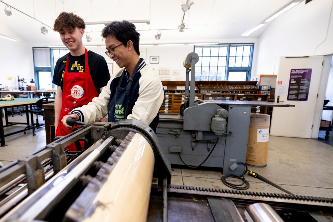 Students work on projects in a collaborative classroom space and operate equipment in a print design studio.