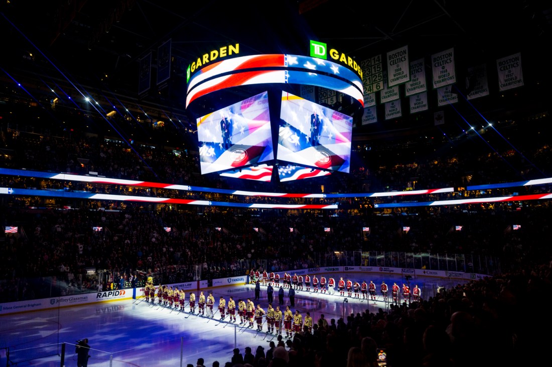 Northeastern and BC mens hockey players lined up on the ice at TD Garden before teh game.