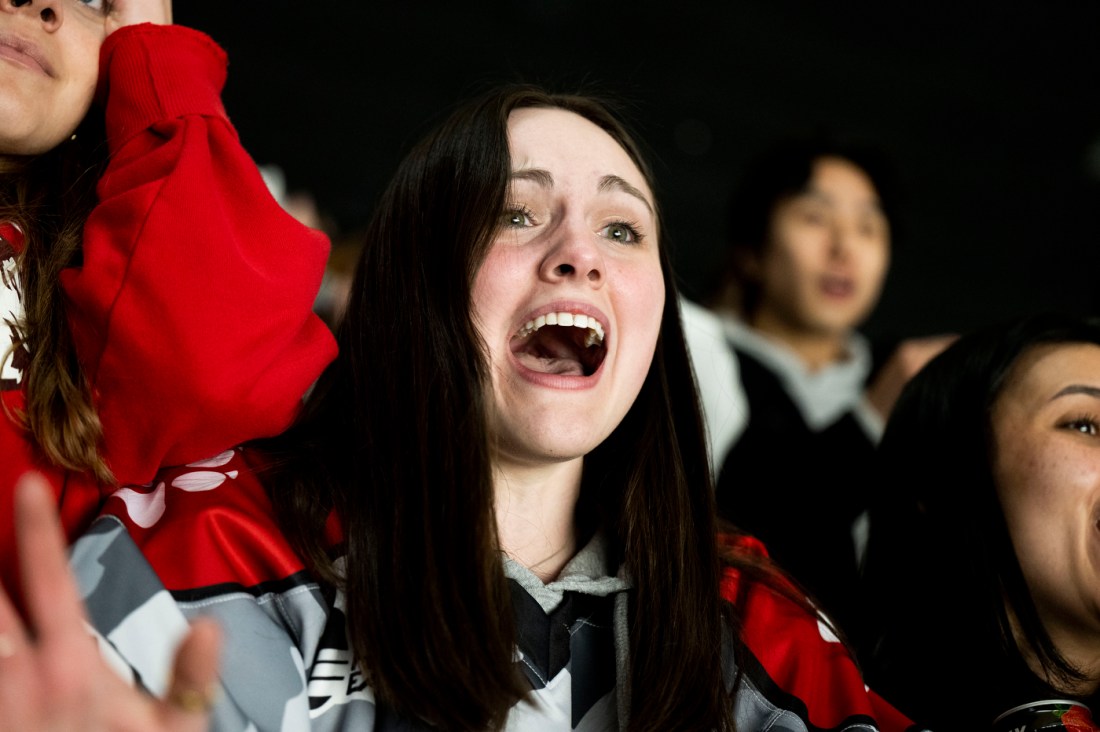 A student cheering in the fan section at TD garden.