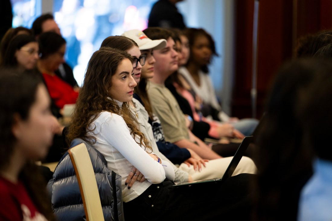 A row of audience members listening intently at the fireside chat.