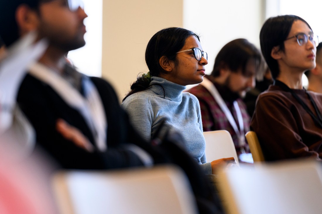 Several audience members sitting in chairs listening at the WIoT forum.