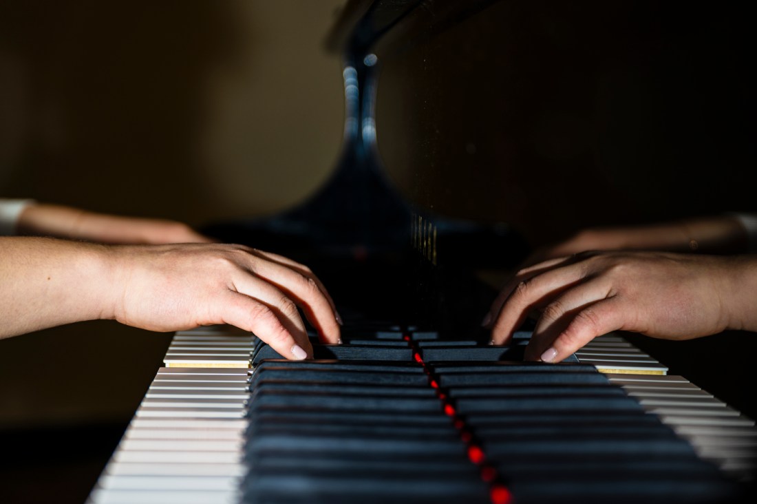 Bonnie Liu's hands on the keys of the piano.