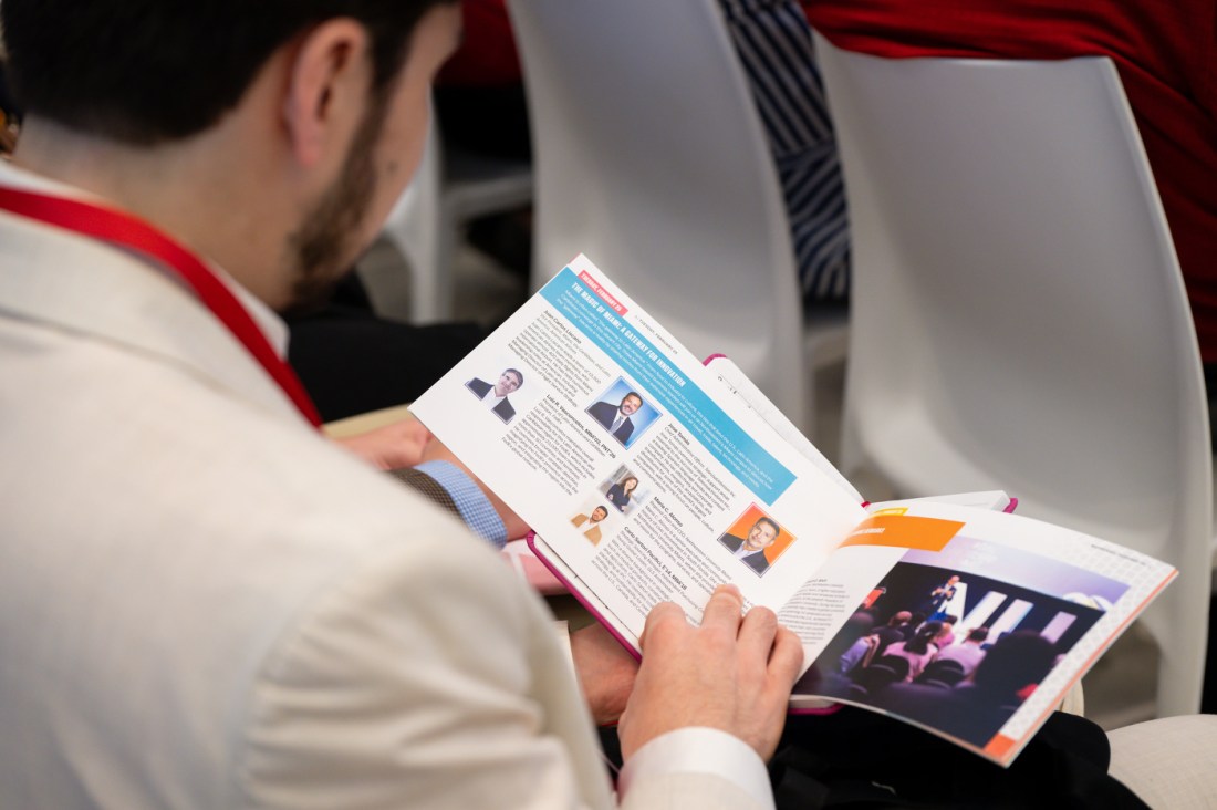 An audience member flipping through a pamphlet.