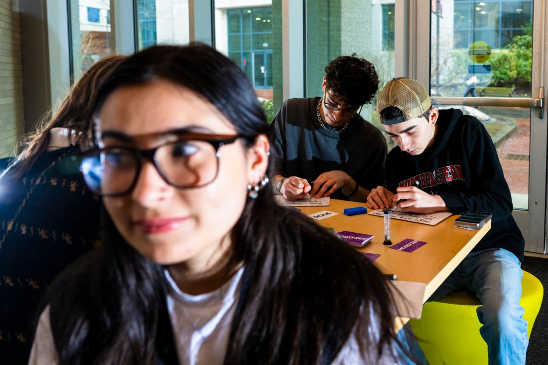 Several people sitting in a room working on a game. 